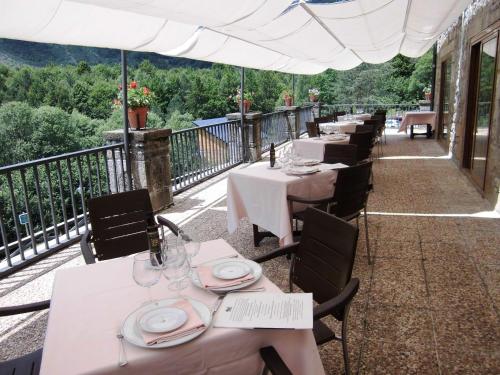 a row of tables on the balcony of a restaurant at Parador de Bielsa in Espierba