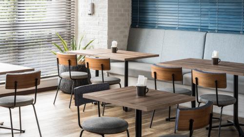 a group of tables and chairs in a restaurant at Tissage Hotel Naha by Nest in Naha