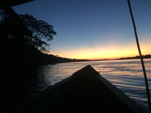 a view from the back of a boat on a river at Hacienda Herrera Tambopata in Puerto Maldonado
