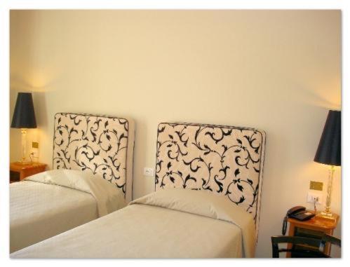 Postel nebo postele na pokoji v ubytování Hotel Certosa