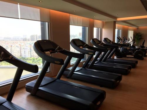 a row of treadmills in a gym with a window at The Anandi Hotel and SPA - Luxury Healing Hotel for Wellbeing in Shanghai