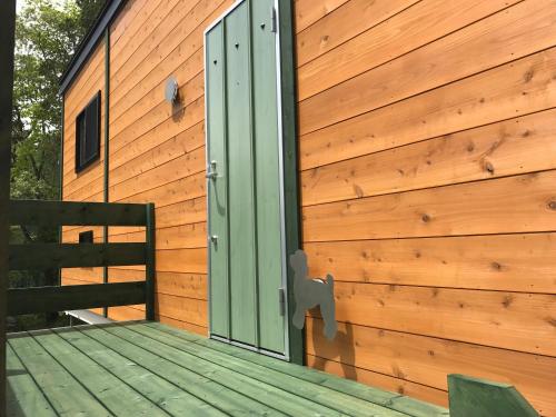a door on the side of a wooden building at DogrunCafe & Resorts JENNIE West-Karuizawa in Miyota