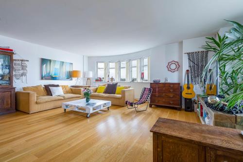a living room with a couch and a table at Spectacular River Thames View in London