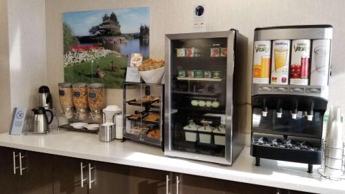 a counter with two refrigerators with food and drinks at Best Western Plus Barrie in Barrie