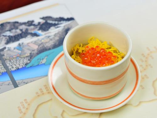 a cup of food on a plate on a table at Iwamotoro in Fujisawa