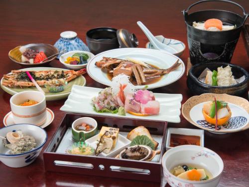 a table with plates of food and bowls of food at Iwamotoro in Fujisawa
