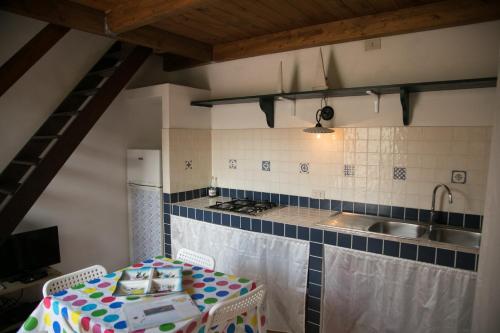 a kitchen with a table and a sink at Case Canino in Favignana