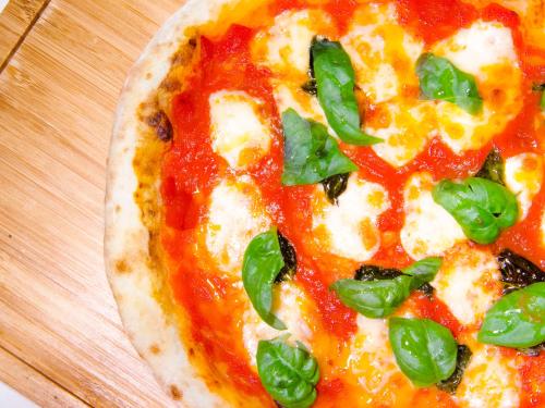 a pizza sitting on top of a wooden table at Hotel Den Haag Huis Ten Bosch in Sasebo