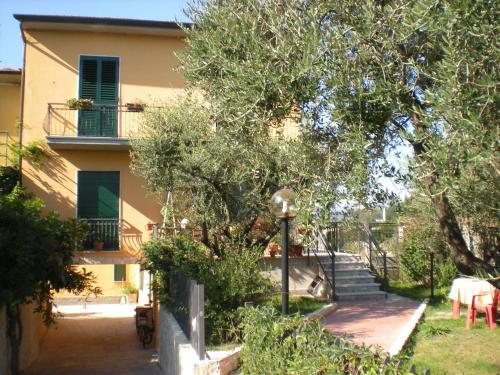 a villa with a staircase leading up to a house at B&B Al Calcandola in Sarzana