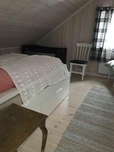 a bedroom with a bed and a table and a chair at Jotunheimen Exclusive in Randsverk