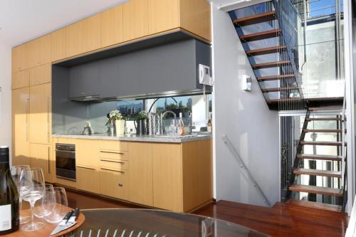 a kitchen with a spiral staircase in a house at Saint George - The Townhouse in Melbourne