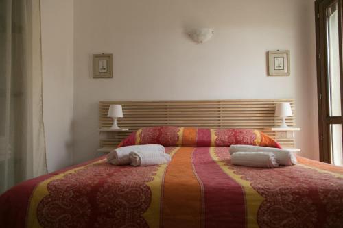 a bedroom with a bed with two towels on it at Case Canino in Favignana