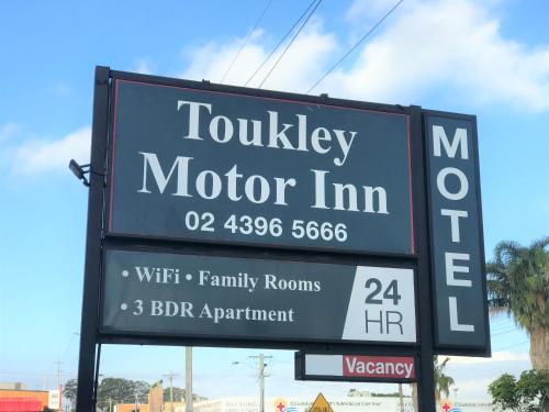 a sign for a motor inn on a street at Toukley Motor Inn in Toukley