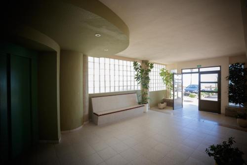 a living room with a couch and a large window at Apartamentos Florida II in Peñíscola