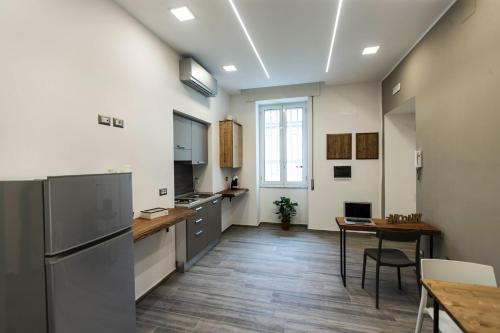 cocina grande con mesa y nevera en GB Central Station Napoli, en Nápoles