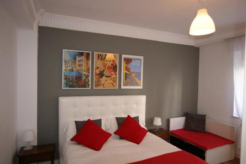 a bedroom with a white bed with red pillows at Guelbenzu by clabao in Pamplona
