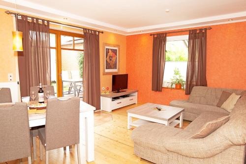 a living room with a couch and a table at Ferienhaus Mara in Borkum