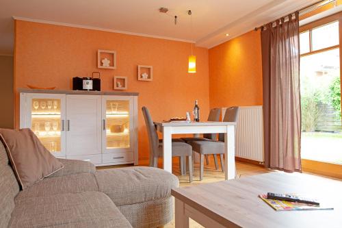 a living room with a couch and a table at Ferienhaus Mara in Borkum