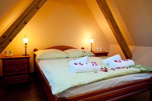 a bedroom with a bed with two pillows on it at Willa Ostoja in Świeradów-Zdrój