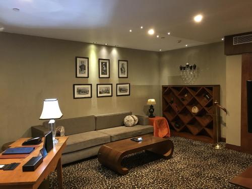 a living room with a couch and a wine cellar at Radisson Blu Hotel MBD Ludhiana in Ludhiana