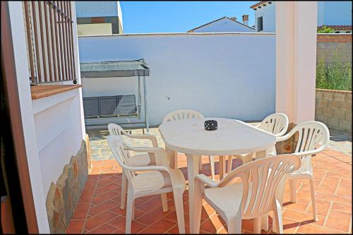 a white table and chairs on a patio at Chalet Ruperto in Conil de la Frontera