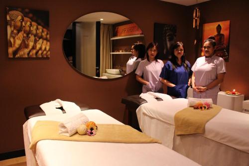 a group of women standing in a room with beds at Privilege Hotel & Spa in Tirana
