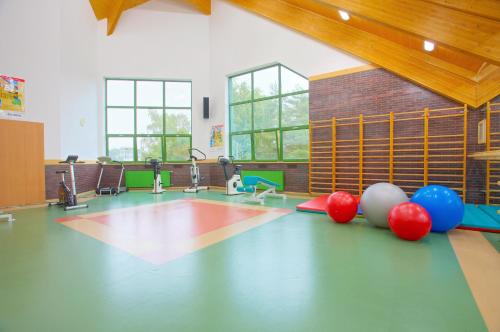 a gym with a bunch of balls on the floor at Geovita Dąbki in Dąbki