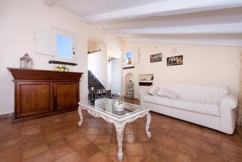 a living room with a white couch and a coffee table at Villa Alba d'Oro - Historic luxury villa in Amalfi