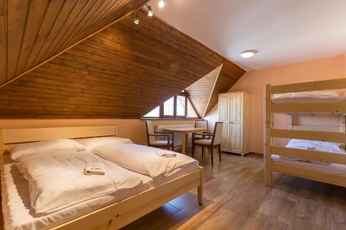 A bed or beds in a room at Penzion Šatovské lípy