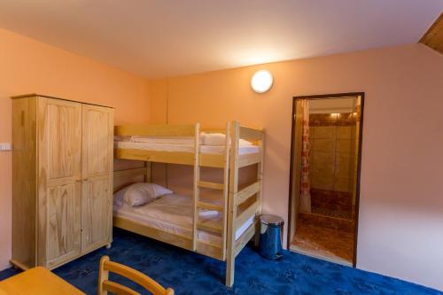 a room with two bunk beds and a mirror at Penzion Šatovské lípy in Šatov