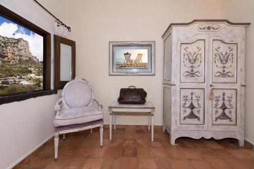 a living room with a wooden floor and a wooden dresser at Villa Alba d'Oro - Historic Luxury Villa in Amalfi