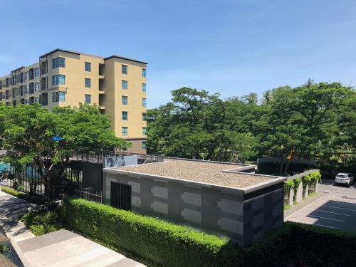 a building in front of a tall building at Rain Cha-am Huahin By Sake in Cha Am
