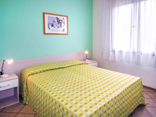 ビビオーネにあるAppartamento Rossellaのベッドルーム1室(黄色のベッドカバー付)