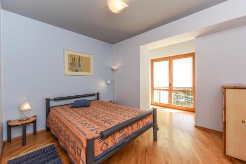 En eller flere senge i et værelse på Vanagas Apartments
