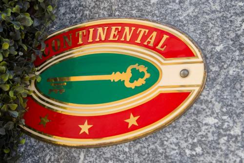 a sign that says international with a key on it at Hotel Continental in Turin