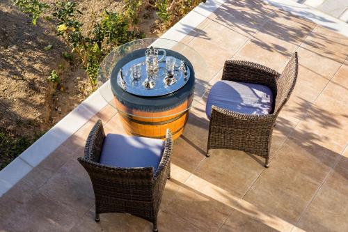 a table and two chairs and a table with a fountain at Amazing Sea View Villa in Parikia