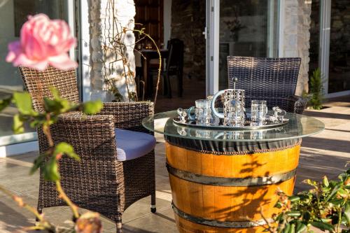 a glass table and chairs on a patio at Amazing Sea View Villa in Parikia