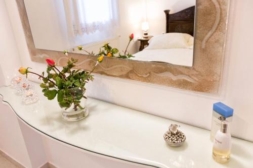 a mirror on top of a glass table in a bedroom at Amazing Sea View Villa in Parikia