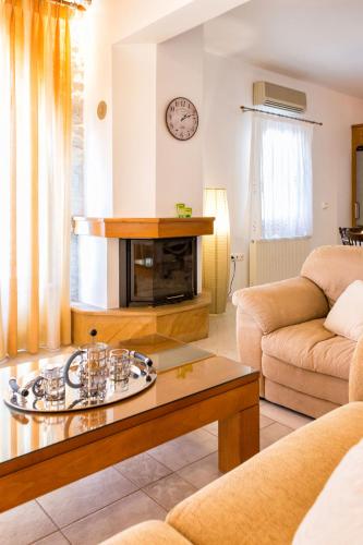 a living room with a couch and a coffee table at Amazing Sea View Villa in Parikia