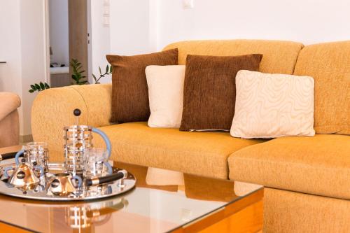 a living room with a couch and a coffee table at Amazing Sea View Villa in Parikia