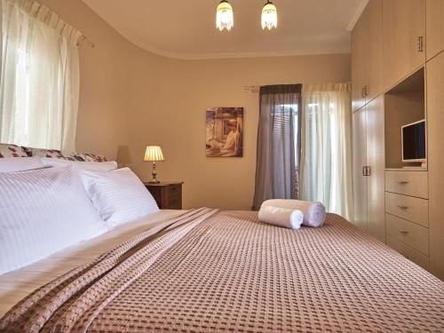 a bedroom with a bed with a stuffed animal on it at Giovanna's Lux Apartment in Zakynthos