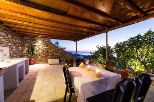a table with a white table cloth on a patio at Amazing Sea View Villa in Parikia