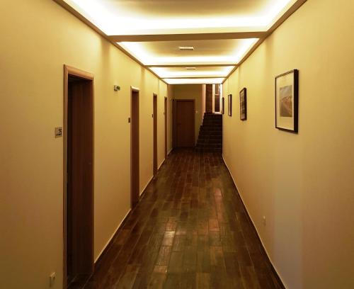 an empty hallway in an office building with wood floors at Hotel Villa Panorama in Belgrade