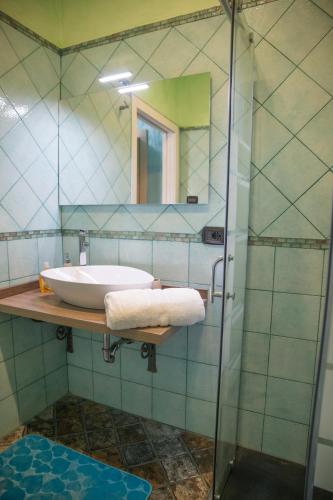 a bathroom with a sink and a glass shower at Acqua Azzurra in Alghero