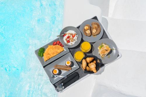 a tray of food on a table with breakfast foods at Sophia Boutique Hotel in Oia