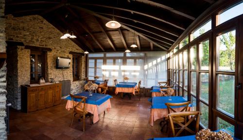 a dining room with blue tables and chairs at Hotel Rural Casona Trabadelo in Vegadeo