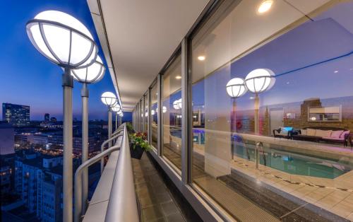a balcony with lights and a view of a city at Clayton Hotel Düsseldorf City Centre in Düsseldorf