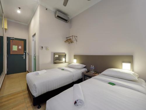 Postel nebo postele na pokoji v ubytování Tune Hotel - 1Borneo Kota Kinabalu