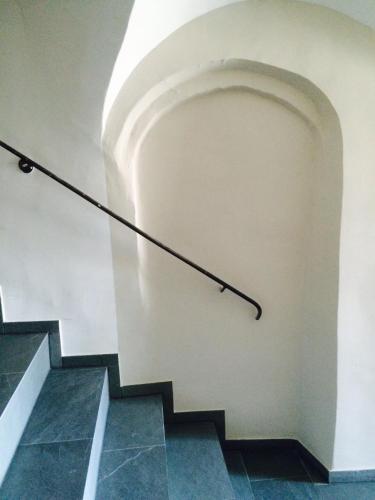 a staircase in a building with a hand rail at Faktorei in Innsbruck