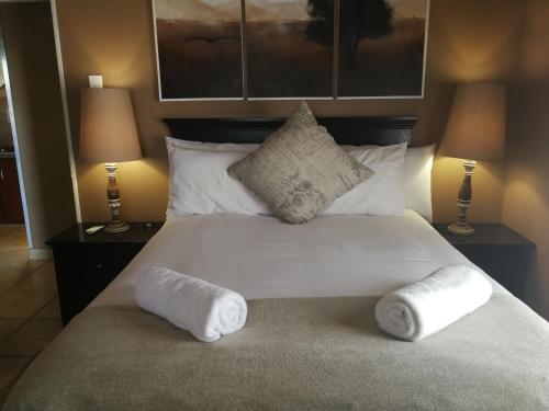 a bedroom with a bed with two towels on it at Augrabies Falls Lodge & Camp in Augrabies